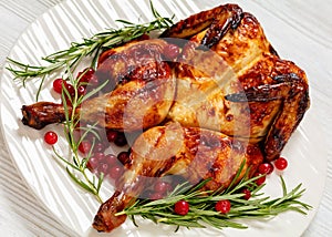 butterflied, spatchcock roast chicken on a plate photo