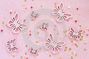 butterflies and confetti on pink background monochromeon.