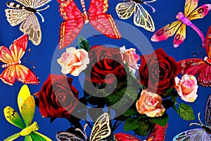 Butterflies, dragonflies flying on a bouquet of roses, on a blue sky background.