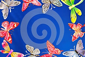 Butterflies and dragonflies frame for design, on blue sky background.