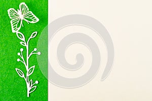 A Butterfly and flower made from carve paper or cutting on green and yellow background with empty space for your text or message