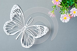 A butterfly Paper Cut with flower on grey colour background