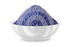 Butterfly pea flower powder or blue matcha in round bowl isolated on white. Front view