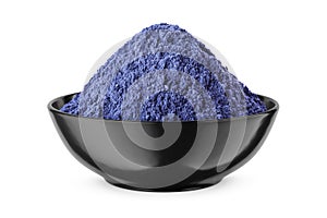 Butterfly pea flower powder or blue matcha in round bowl isolated on white. Front view