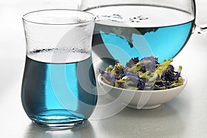 Butterfly pea flower tea and dried butterfly pea tea flowers close up