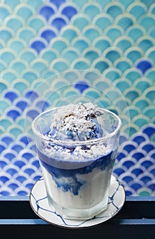 Butterfly pea ice cream. A butterfly peas signature dessert : blue ice cream in milk latte. icing topping on top.