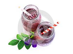 Butterfly pea juce in grass bottle with leaf and flower on white background, herb dink for healthy concept