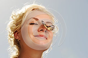 Butterfly sitting on a woman nose