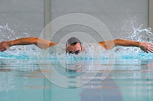 Butterfly stroke in indoor pool