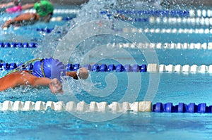 Butterfly swimmers during a race at a swim meet