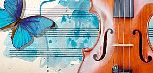 Butterfly, violin and notes. Blue morpho butterfly and violin. Melody concept. Photo of old music sheet in blue watercolor paint.