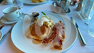 Buttermilk pancakes, bacon and coffee breakfast at a restaurant on a cruise ship