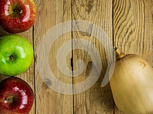 Butternut Squash Pumpkin Ripe Red Green Apple on Weathered Wood Background. Autumn Fall Thanksgiving Harvest. Copy Space