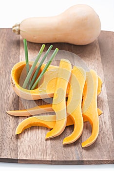 Butternut squash on wood cutting board.