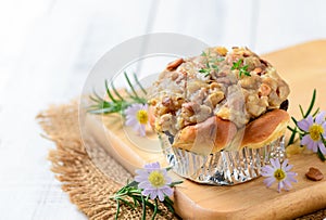 Butterscotch Bread with nuts on top on wood plated