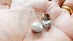 Button cell battery on hand