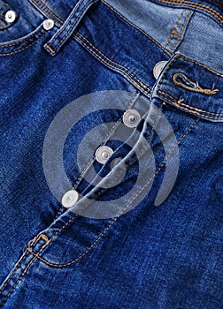 Button closure on the blue jeans