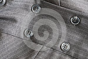 Button on a gray suit