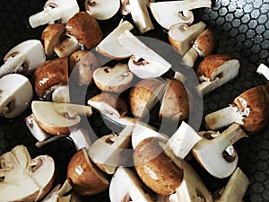 Button mushrooms sliced in a pan