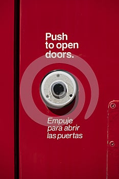 Button for opening doors on red transit train.