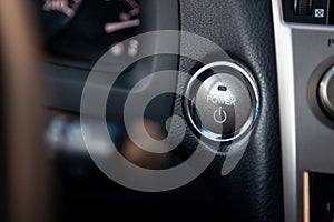 Button start and turn off the ignition of the car engine close-up on the dashboard, electric key, of modern design with elements