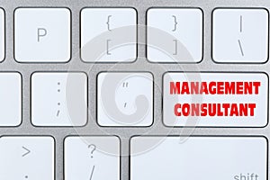 Button with text MANAGEMENT CONSULTANT on keyboard, top view