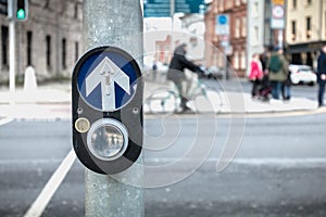 Button to activate pedestrian crossing on the road in Dublin