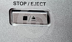 Button to stop and eject with symbols on the control panel.