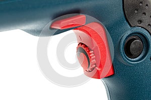Button for turning on an electric drill, a regulator of revolutions of rotation and reverse, isolated on white background photo