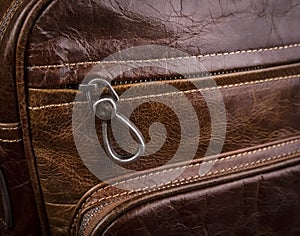 Buttoned zipper on a leather bag for men