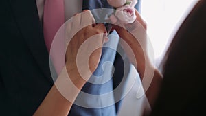 Buttoning a jacket. Stylish man in a suit fastening buttons on his jacket preparing to go out. Close up