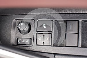Buttons controlling the windows inside a car, control and electric mirror adjustment