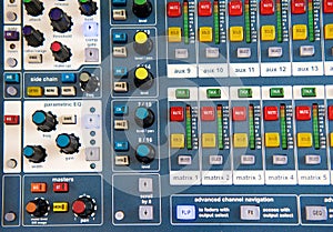 Buttons and knobs on stereo audio mixer