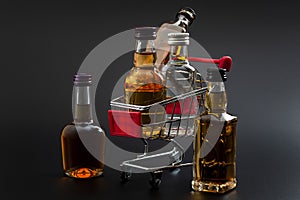 Buy booze, shopping the liqueur aisle and purchase of alcoholic beverages concept theme with mini bottles of alcohol in a small