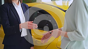 Buy car, sales manager woman sell automotive, give key to buyer and do handshake close up. Spbas