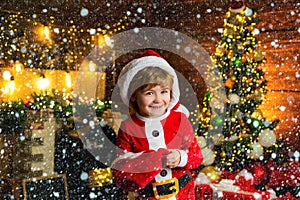 Buy christmas gifts online. Christmas shopping concept. Holidays and winter childhood concept. Smiling little boy in
