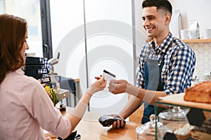 Buy Coffee. Woman Paying With Credit Card In Cafe