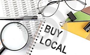 BUY LOCAL - the inscription of text on the Notepad, and chart. Business concept
