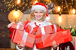 Buy lots of gift wrappers. She deserves all best. Ribbons bows accessories. Girl santa hat hold wrapped gift boxes. New