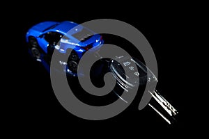 Buy new car, rental or leasing - automobile model with remote key on black background