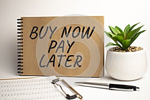 BUY NOW PAY LATER paper notepad on office work place