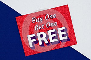 Buy one get one free type message on a glitter red greeting card