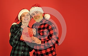 Buy present. Christmas party. Couple in love with gift. Santa Claus style. Christmas time. Man and woman christmas