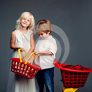 Buy products. Play shop game. Cute buyer customer client hold shopping cart. Girl and boy children shopping. Kids store