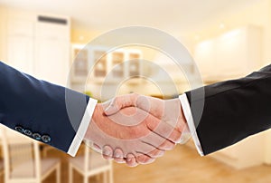 Buy or sale real estate concept with businessmen handshake