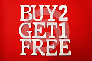 Buy two get one Free Sale Promotion on red background