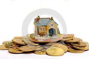 Buy your Dream House concept with Golden Coins stack