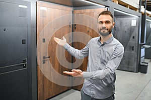 Buyer chooses door in store. Shop window of doors. A large selection of doors for house