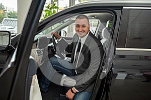 buyer client inside modern car at showroom, concept of sale or rent vechile