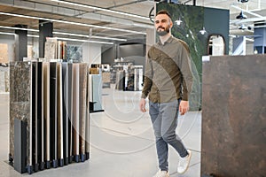 buyer examines ceramic tiles in a construction store
